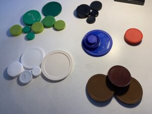 small piles of jar lids sorted by color