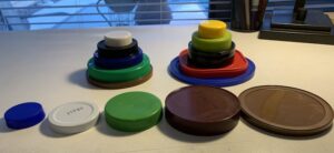 row of 5 jar lids in order of size; 2 piles of lids stacked by size (smallest on top)