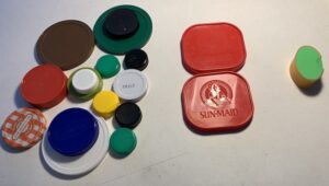 lids sorted by shape: circle shapes of assorted colors and size; 2 square lids; 1 oval lid